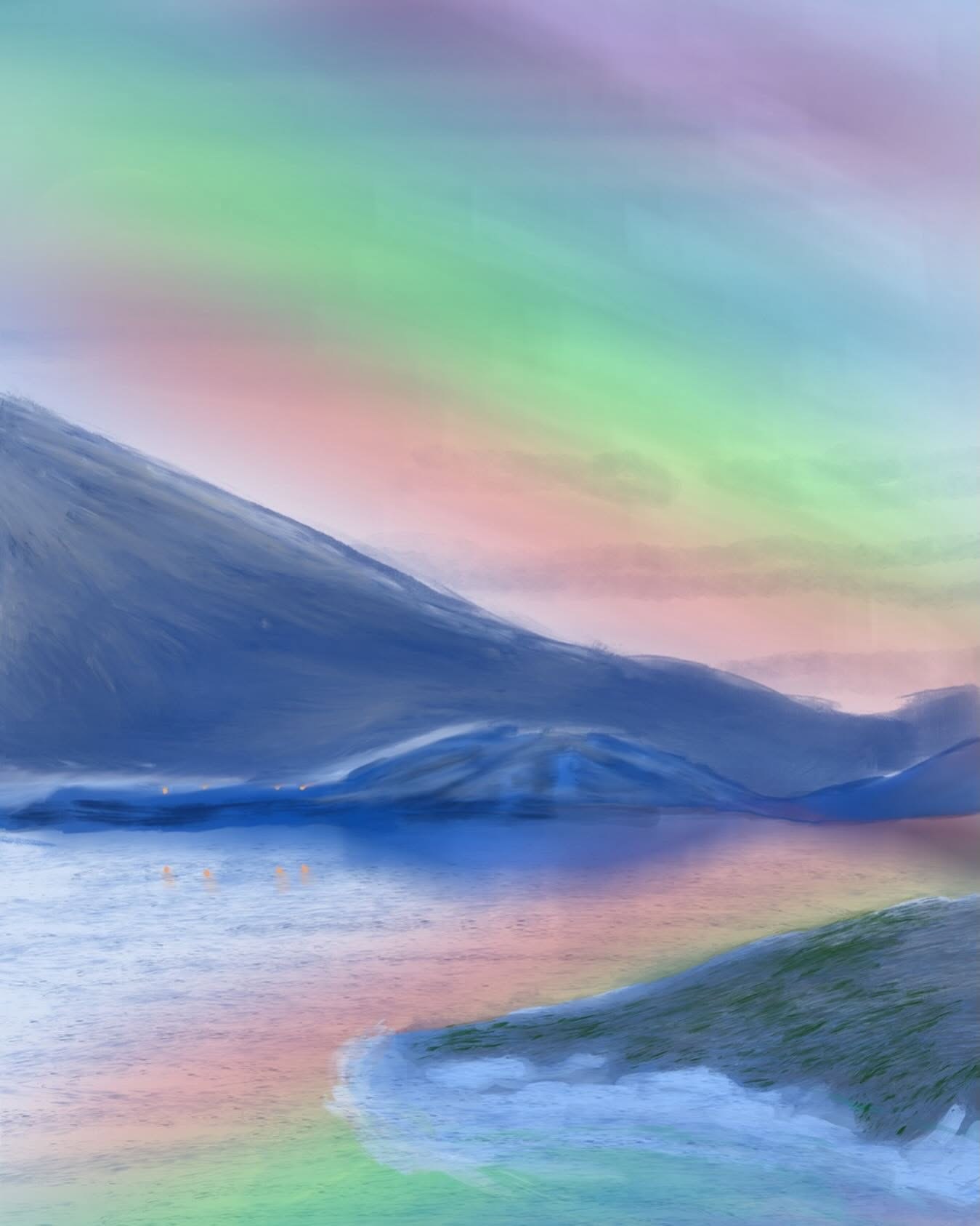 Northern lights over a still bay: bands of green, pink and violet light across the sky, a dark blue mountain sloping to the water, and a few small orange lights along the far shore reflected in the water